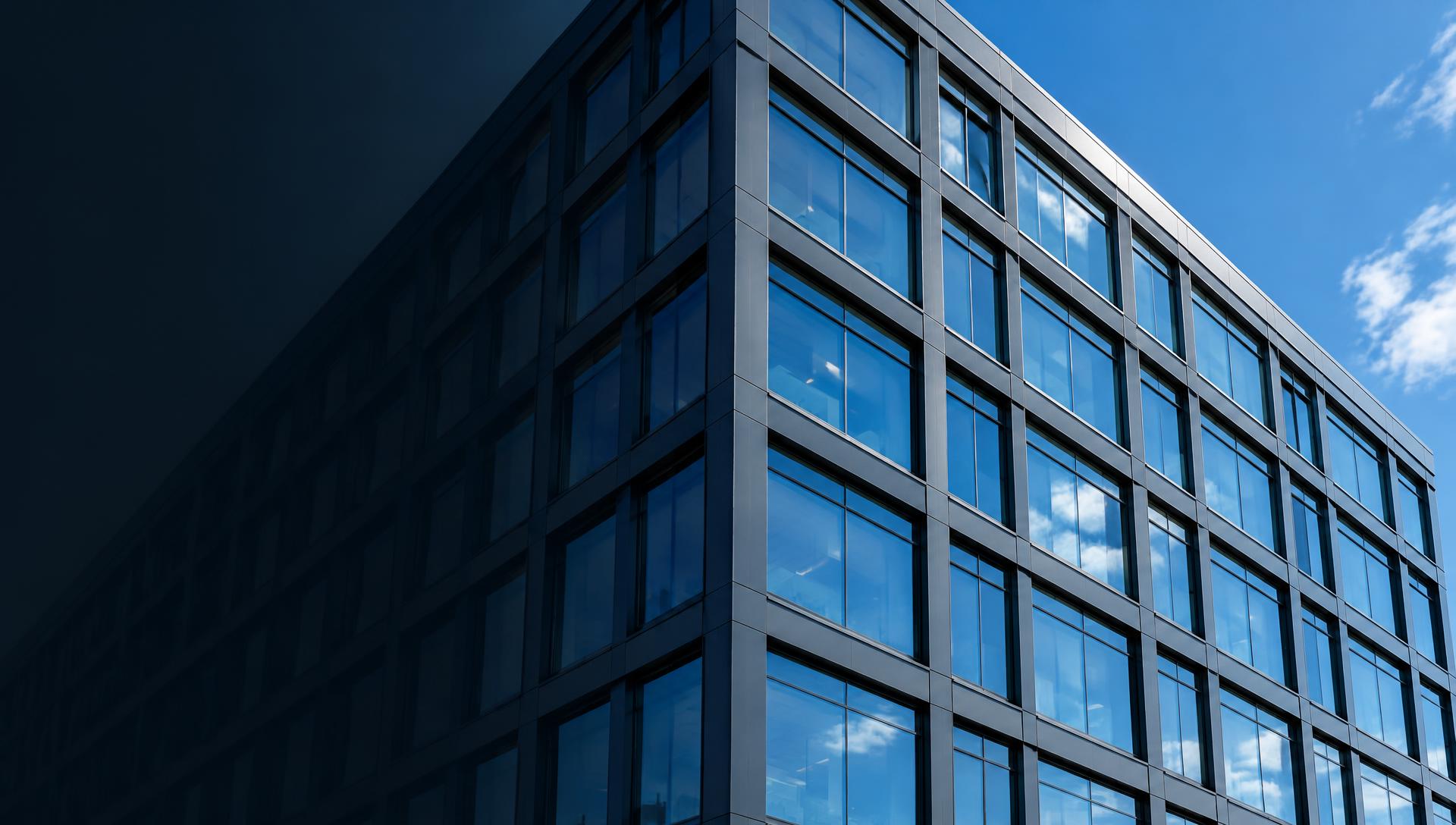 Modern commercial building with glass windows and a steel facade